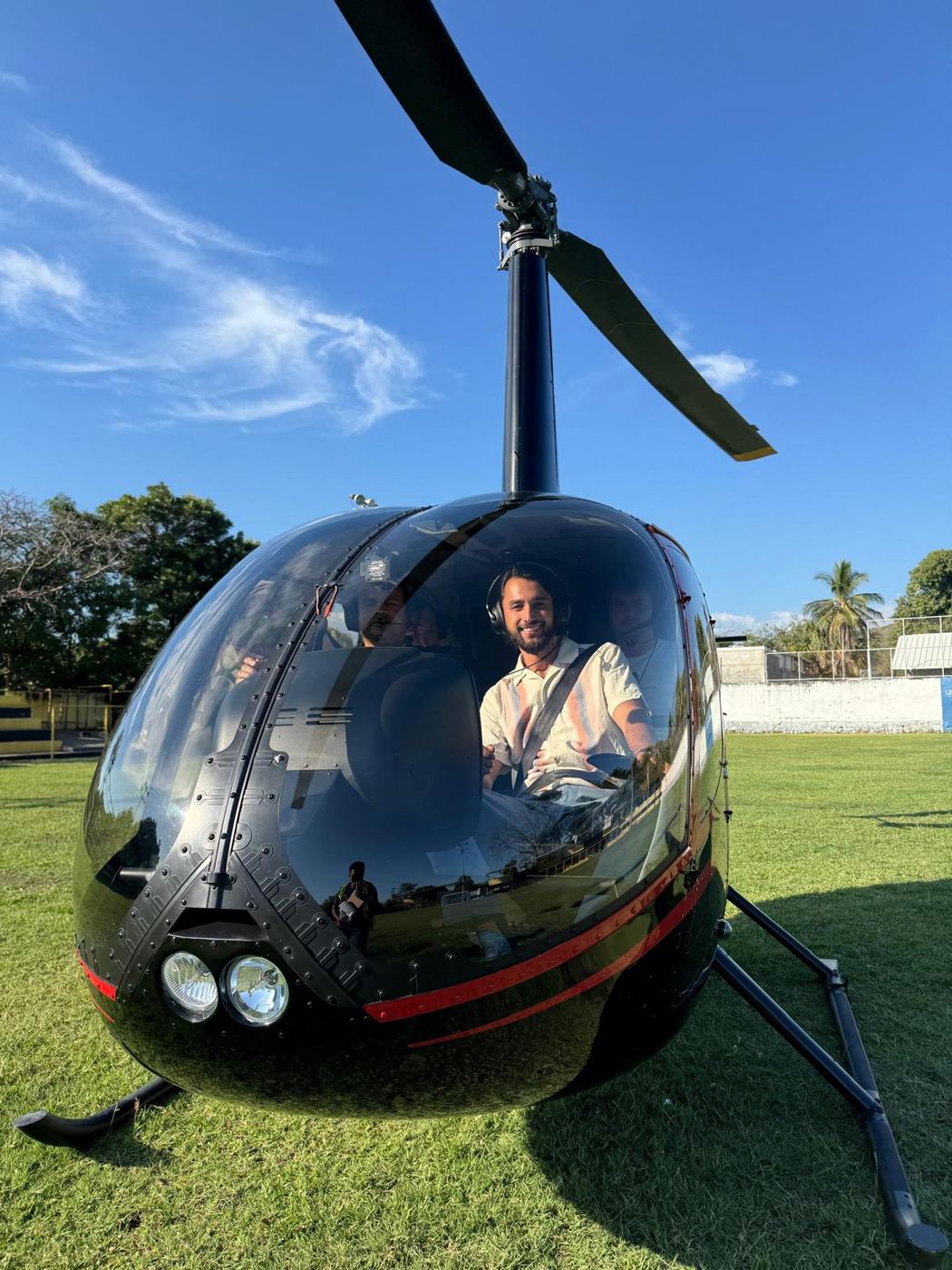 Chris smiling from a helicopter cockpit