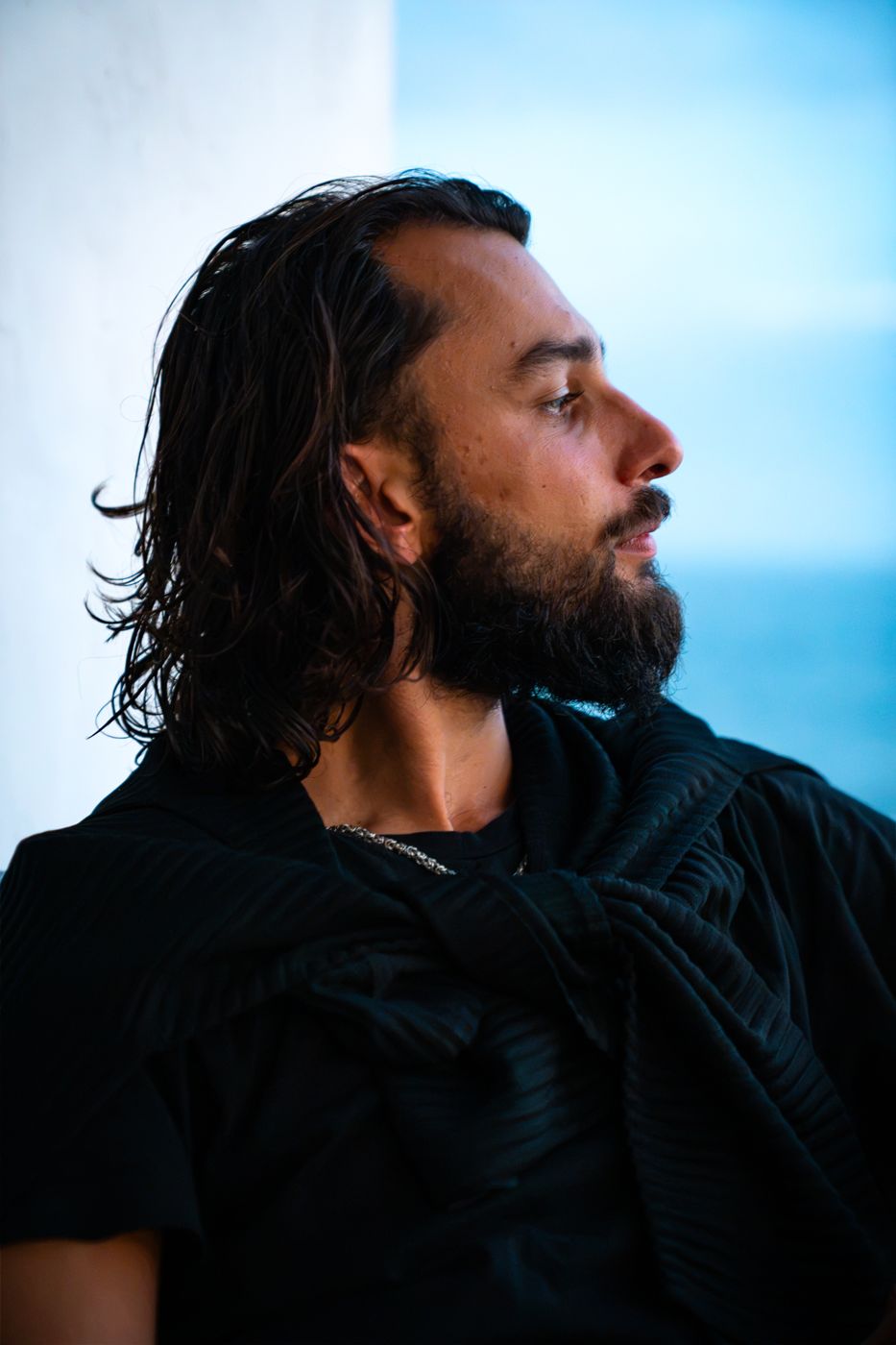 Profile portrait of Christopher Wedick against the ocean at dusk