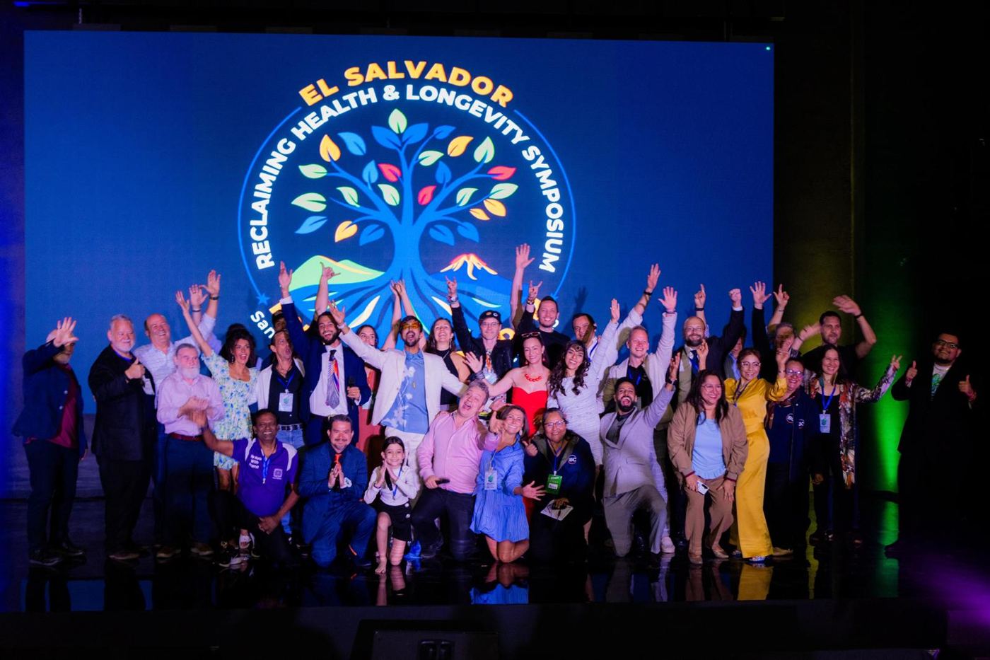 Speakers celebrating on stage at the Reclaiming Health & Longevity Symposium